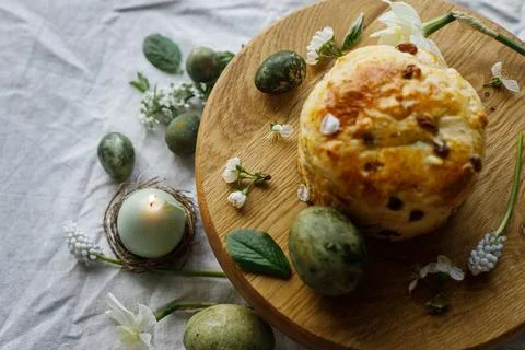 Easter celebration. Stylish green easter eggs, easter bread, candle and che.. Stock Photos