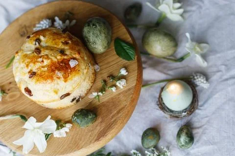 Easter celebration. Stylish green easter eggs, easter bread, candle and che.. Stock Photos