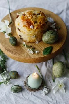 Easter celebration. Stylish green easter eggs, easter bread, candle and che.. Stock Photos