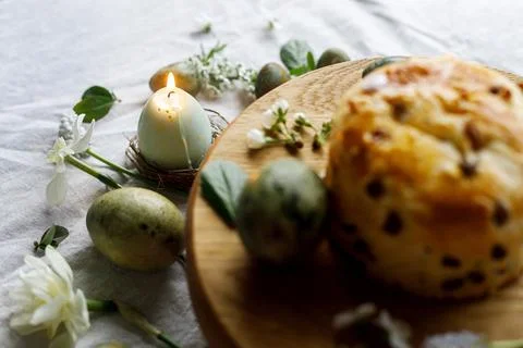 Easter celebration. Stylish green easter eggs, easter bread, candle and che.. Stock Photos