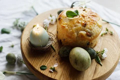 Easter celebration. Stylish green easter eggs, easter bread, candle and che.. Stock Photos