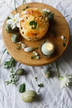 Easter celebration. Stylish green easter eggs, easter bread, candle and che.. Stock Photos