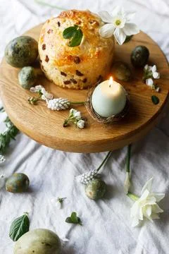 Easter celebration. Stylish green easter eggs, easter bread, candle and che.. Stock Photos