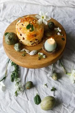 Easter celebration. Stylish green easter eggs, easter bread, candle and che.. Stock Photos