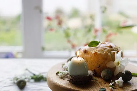 Easter celebration. Stylish green easter eggs, easter bread, candle and che.. Stock Photos