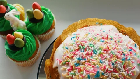 Easter ceramic bunny and cupcakes with sweet colorful eggs Stock Footage 128576157