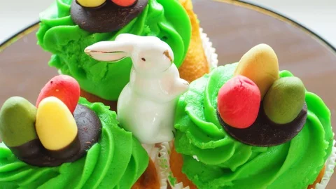 Easter ceramic bunny and cupcakes with sweet colorful eggs Stock Footage 128576823
