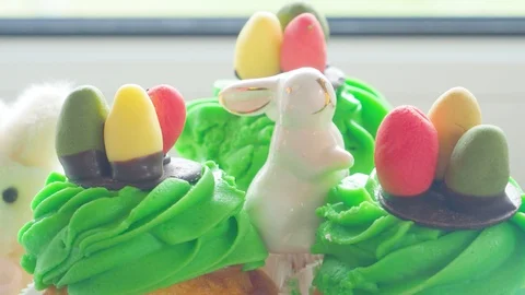 Easter ceramic bunny and cupcakes with sweet colorful eggs Stock Footage 128577130