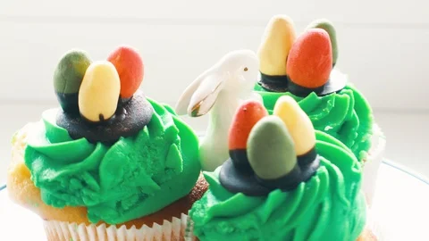 Easter ceramic bunny and cupcakes with sweet colorful eggs Stock Footage 128577471