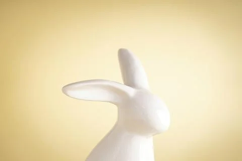 Easter ceramic bunny on yellow background. Close-up Stock Photos