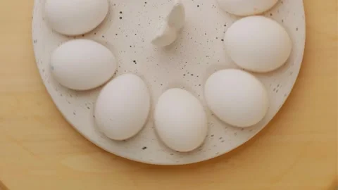 Easter chicken eggs rotating on a festive tray Stock Footage 306919019