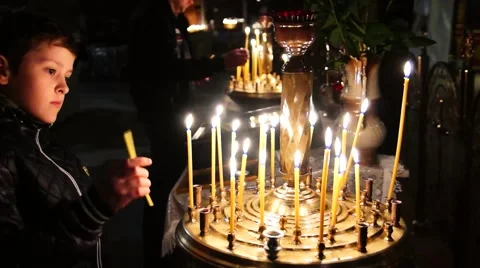 Easter. Child, boy lights, light candles and baptized in the Church. Stock Footage 49107115