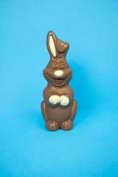 Easter chocolate bunny on a blue background vertically Stock Photos