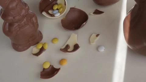 Easter Chocolate Delight with Broken Eggs and Bunnies Filled with Candy Stock Footage 333111390