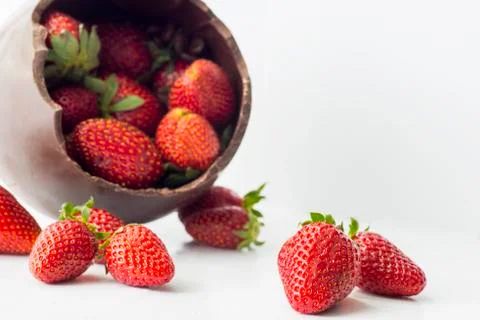 Easter chocolate egg and strawberry on a light background Stock Photos