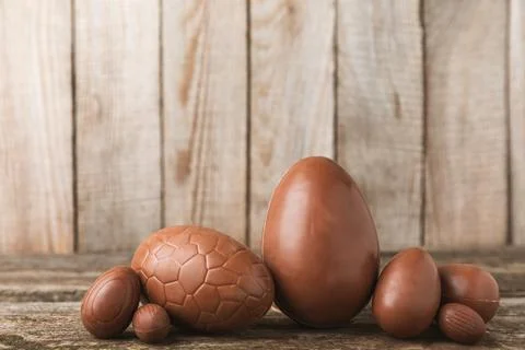 Easter chocolate egg on textured background. Stock Photos