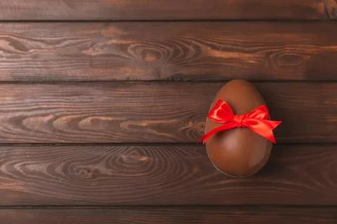 Easter chocolate egg on textured background. Stock Photos