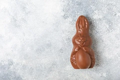 Easter chocolate egg on textured background. Stock Photos
