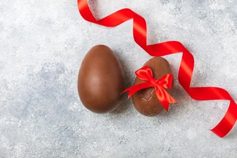 Easter chocolate egg on textured background. Stock Photos