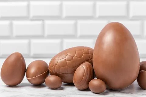 Easter chocolate egg on textured background. Stock Photos