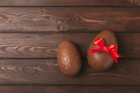 Easter chocolate egg on textured background. Stock Photos