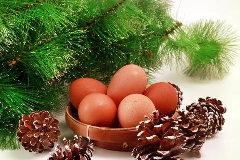 Easter Close-Up of Eggs in a Basket with Several Pinecones and green spruce o Stock Photos