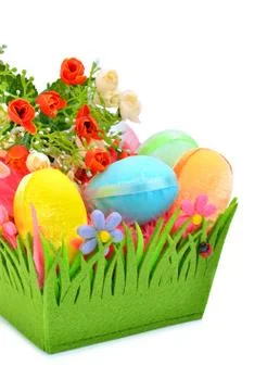 Easter colored cloth eggs, roses in the flowerbed isolated on the white backg Stock Photos