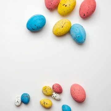 Easter, colored eggs are chaotically arranged on a white background. Stock Photos