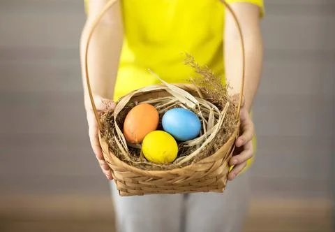 Easter colored eggs in a basket close-up Stock Photos