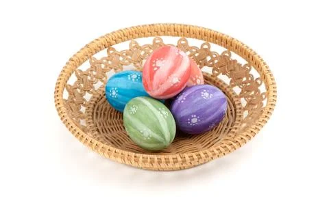 Easter colored eggs in the basket on white background Stock Photos
