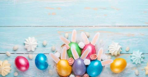 Easter colored eggs with ears of sweets and rabbit ears. Fly lay lay. Easter  Stock Photos