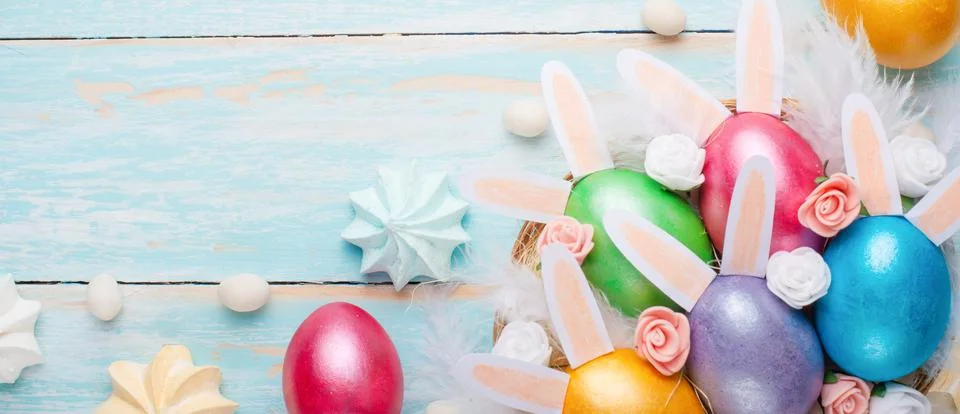 Easter colored eggs with ears of sweets and rabbit ears. Fly lay lay. Easter  Stock Photos