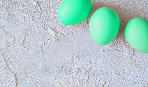 Easter colored eggs on light textured background with space for text Stock Photos