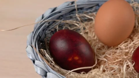 Easter colored eggs lying in the dried grass in a blue basket. Horizontal wiring Stock Footage 138481062