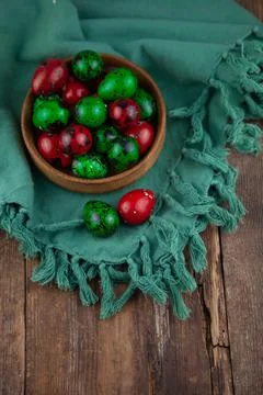 Easter colored eggs. Quail egg of green and red color on a wooden background Stock Photos