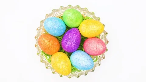 Easter colored eggs rotating in basket with fake grass - Stop motion Stock Footage 125497114