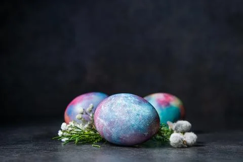 Easter colored eggs with spring flowers Stock Photos