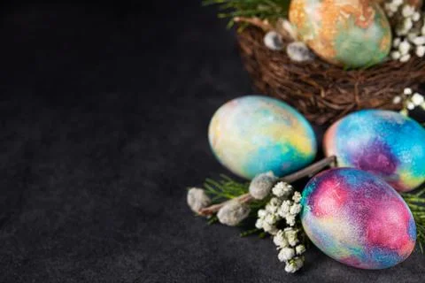 Easter colored eggs with spring flowers Stock Photos