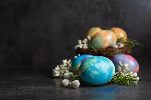 Easter colored eggs with spring flowers Stock Photos