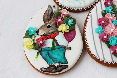 Easter colored gingerbread in the shape of an egg with a rabbit and flowers d Stock Photos