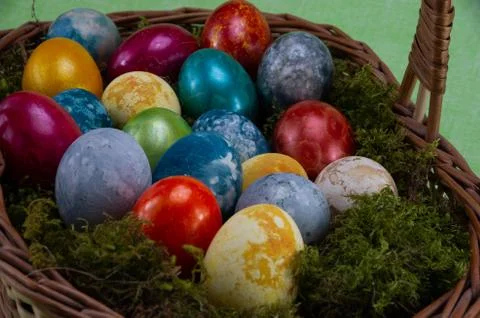 Easter, colored painted eggs in a wicker basket with moss Stock Photos