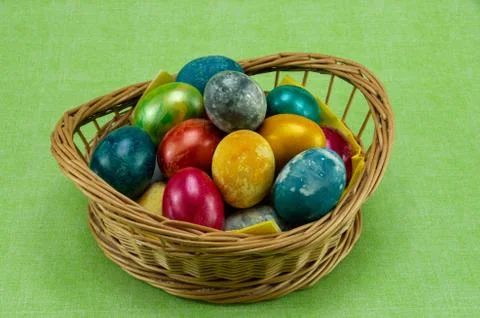 Easter, colored painted eggs in a wicker basket Stock Photos