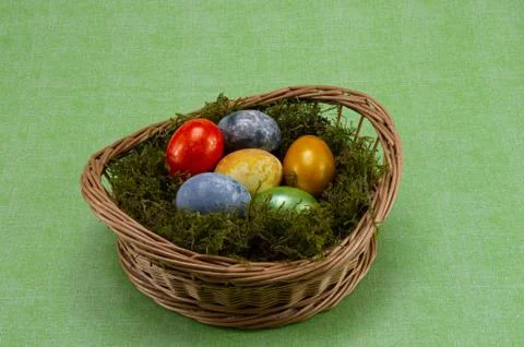 Easter, colored painted eggs in a wicker basket with moss Stock Photos