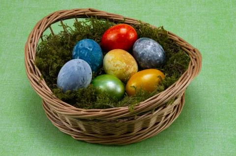 Easter, colored painted eggs in a wicker basket with moss Stock Photos