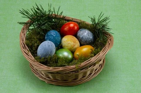 Easter, colored painted eggs in a wicker basket with moss Stock Photos