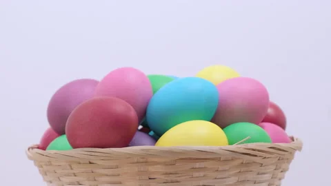 Easter colorful chicken eggs rotating in basket on light background Video stock 171060221