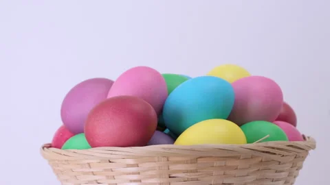 Easter colorful chicken eggs rotating in basket on white background Stock Footage 171611482