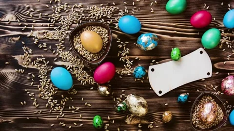Easter colorful eggs, chicken and quail, lie on wooden table. Stock Footage 85932129
