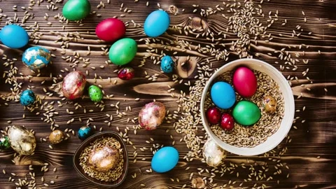 Easter colorful eggs, chicken and quail, lie on wooden table. Stock Footage 85932474