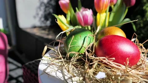 Easter colorful eggs rotate in nest with hey outdoor in sunny warming day. Stock Footage 234547773